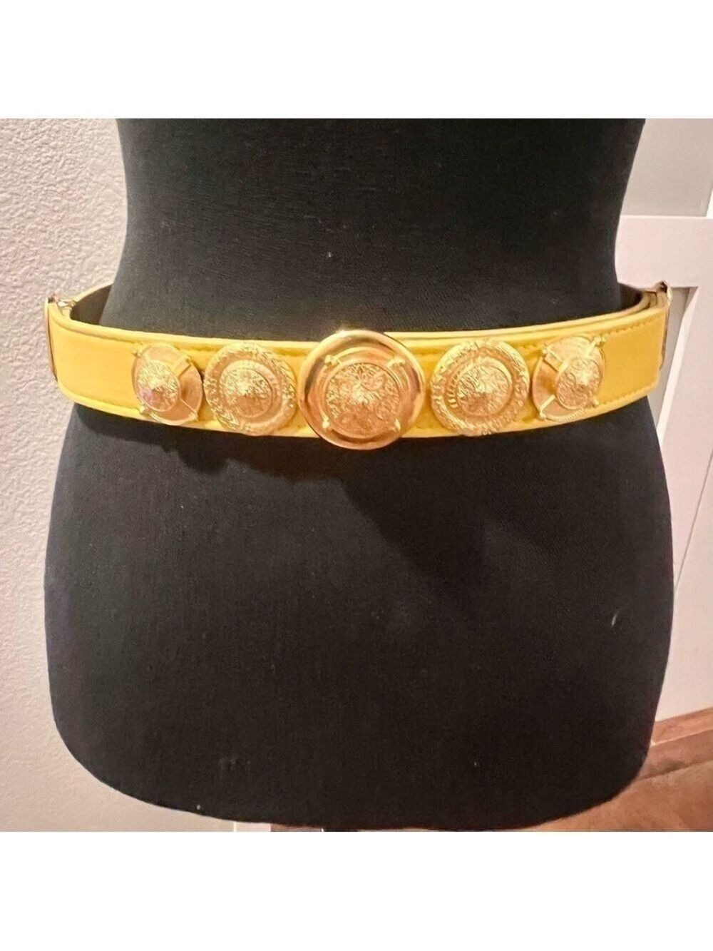 Vintage yellow belt with gold tone medallions.  Small.